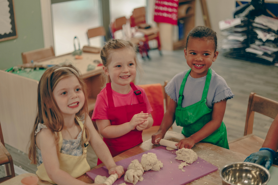 30 hours funded childcare for 9 months - school age A baby is crawling down a wooden indoor climbing frame